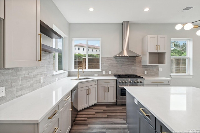 159 E Davis Ct Unit 102, San Antonio, TX 78209 - kitchen with visible vents, a sink, light countertops, stainless steel appliances, and wall chimney exhaust hood