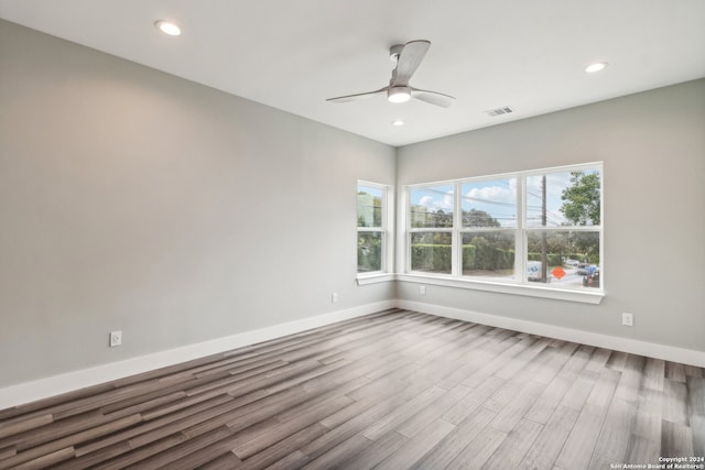 spare room with ceiling fan and wood-type flooring