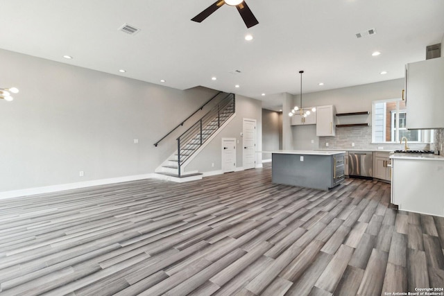 159 E Davis Ct Unit 102, San Antonio, TX 78209 - kitchen featuring a center island, a ceiling fan, open floor plan, wood finished floors, and visible vents