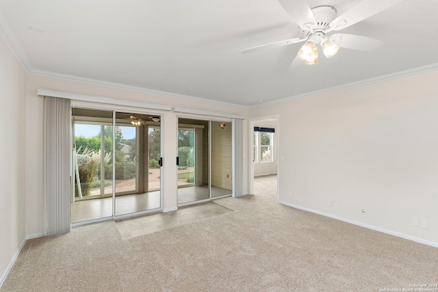 empty room featuring ornamental molding, light colored carpet, and ceiling fan