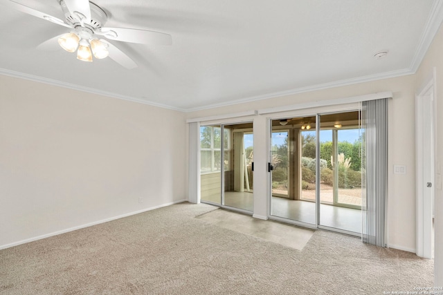 carpeted spare room with ceiling fan, ornamental molding, and plenty of natural light