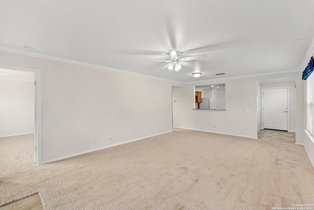 unfurnished living room featuring crown molding, light colored carpet, and ceiling fan