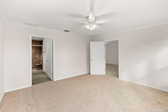 unfurnished bedroom featuring ornamental molding, light colored carpet, connected bathroom, and ceiling fan