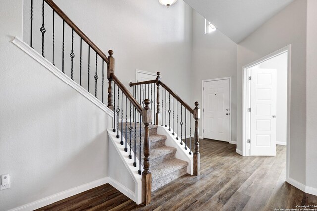 8116 Chasemont Ct, Converse, TX 78109 - entrance foyer featuring dark wood-style floors, baseboards, a high ceiling, and stairs