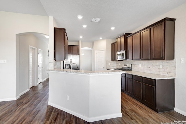 8116 Chasemont Ct, Converse, TX 78109 - kitchen featuring stainless steel appliances, arched walkways, tasteful backsplash, and recessed lighting
