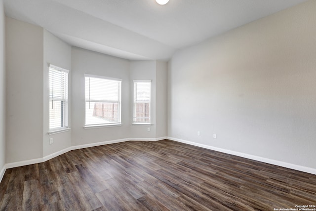 unfurnished room with dark hardwood / wood-style floors