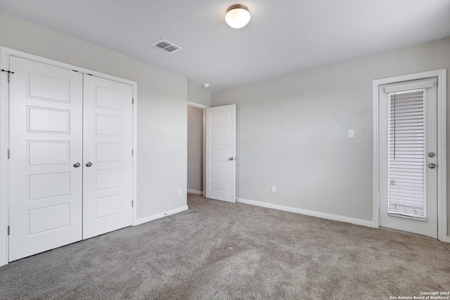 unfurnished bedroom with a closet and carpet