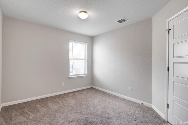 8116 Chasemont Ct, Converse, TX 78109 - empty room with carpet, baseboards, and a textured ceiling