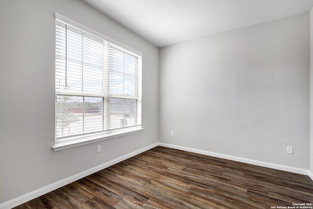 8116 Chasemont Ct, Converse, TX 78109 - spare room with healthy amount of natural light, dark wood-type flooring, and baseboards