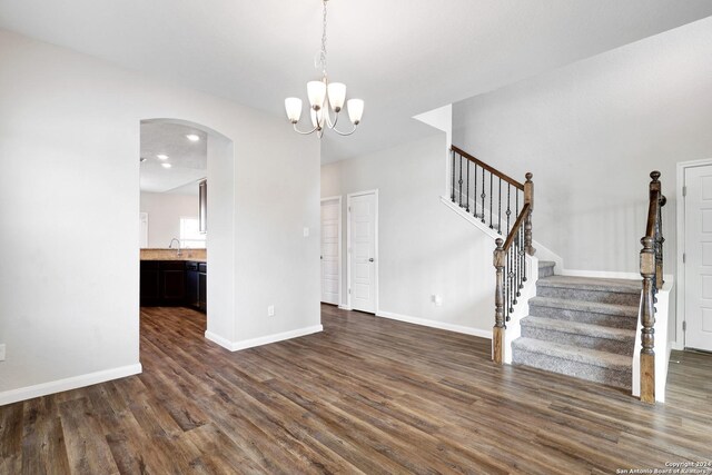 8116 Chasemont Ct, Converse, TX 78109 - unfurnished living room featuring dark wood-type flooring, baseboards, stairway, a chandelier, and recessed lighting