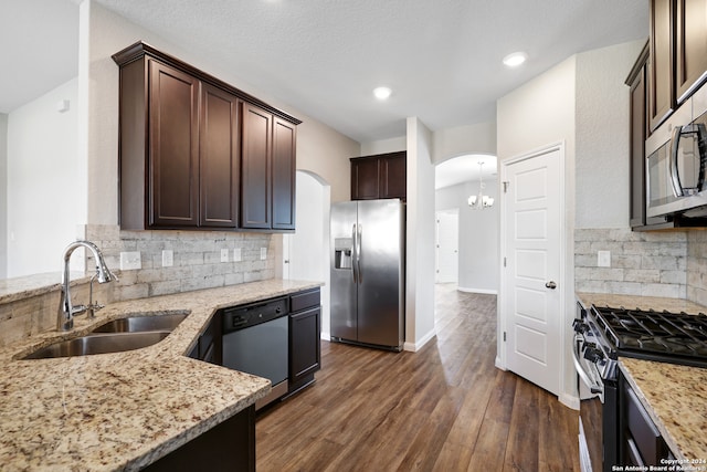 kitchen featuring light stone counters, appliances with stainless steel finishes, sink, and dark hardwood / wood-style floors