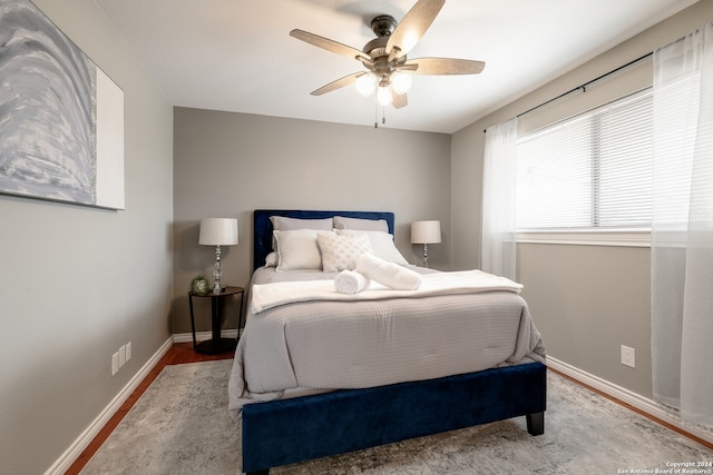 bedroom with hardwood / wood-style flooring and ceiling fan