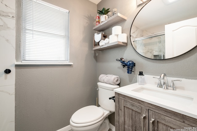 bathroom with vanity, toilet, and an enclosed shower