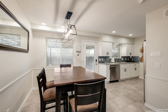 dining room featuring sink and light tile patterned flooring