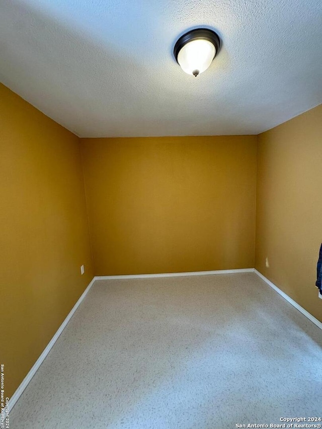 empty room with a textured ceiling