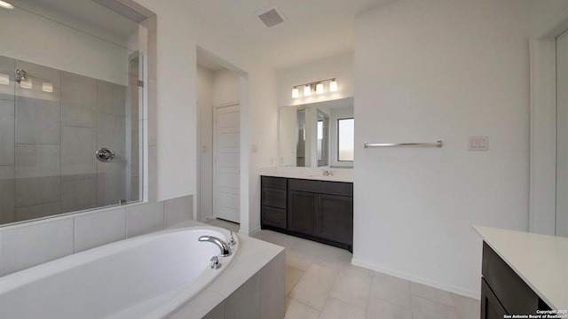 bathroom with a stall shower, a garden tub, visible vents, and vanity