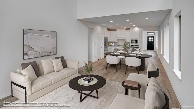 living room featuring baseboards, light wood-style flooring, and recessed lighting