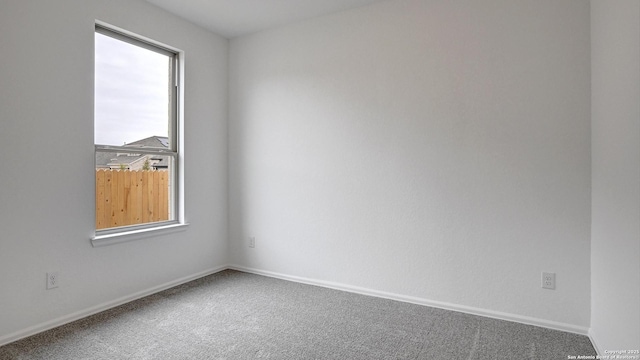 spare room with carpet floors and baseboards