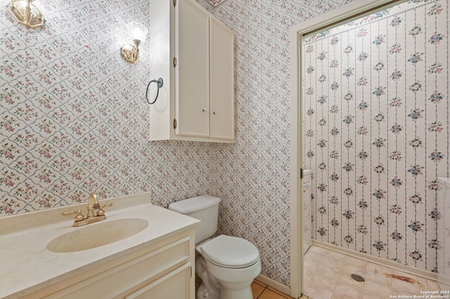 bathroom featuring vanity, toilet, and tile patterned floors