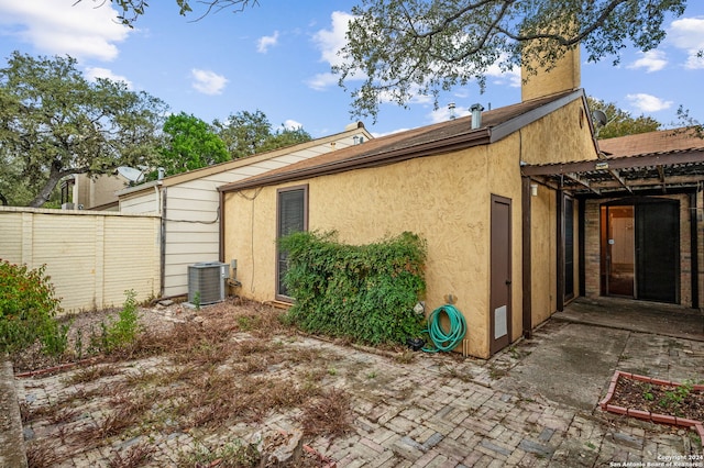 rear view of house with a patio area and central AC unit