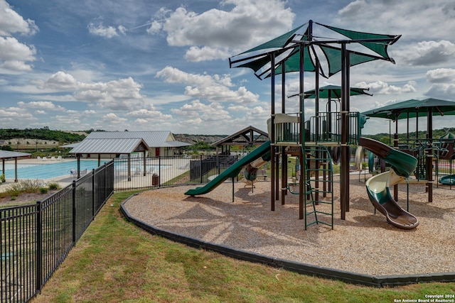 community jungle gym featuring fence