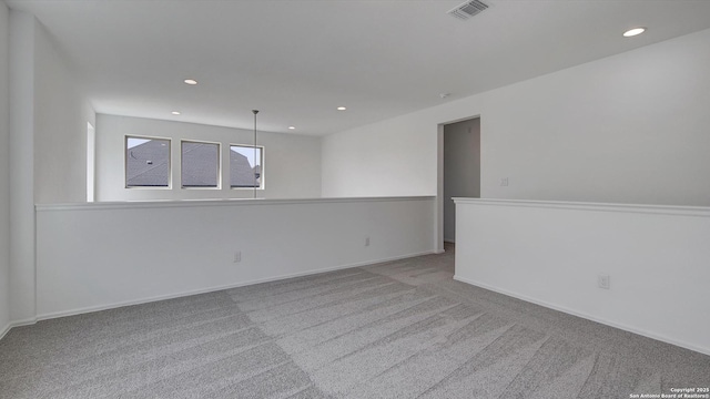 unfurnished room featuring recessed lighting, carpet, visible vents, and baseboards