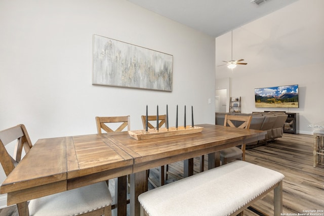 dining space featuring wood-type flooring and ceiling fan