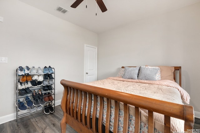 bedroom with dark hardwood / wood-style floors and ceiling fan