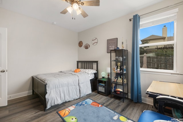 bedroom with dark hardwood / wood-style floors and ceiling fan