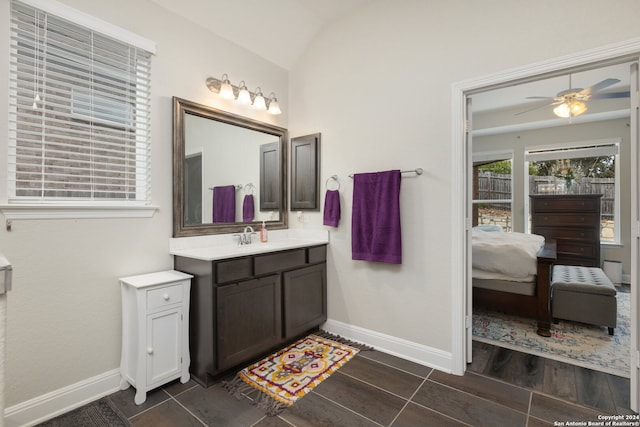 bathroom with vanity, ceiling fan, hardwood / wood-style flooring, and lofted ceiling