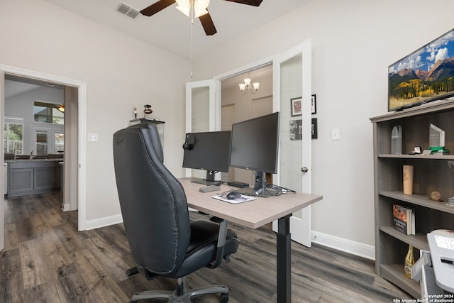 office featuring sink, dark wood-type flooring, vaulted ceiling, and ceiling fan with notable chandelier