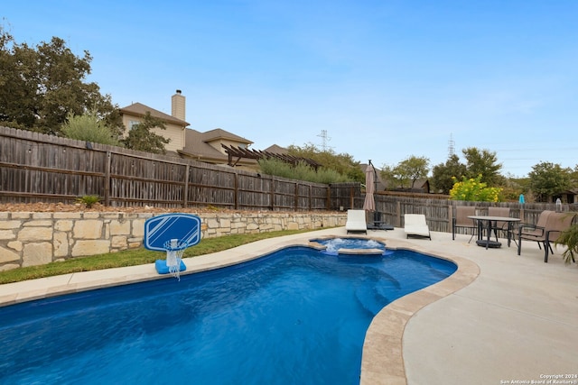 view of swimming pool with an in ground hot tub and a patio