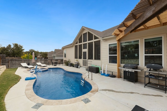 view of swimming pool with a grill and a patio area