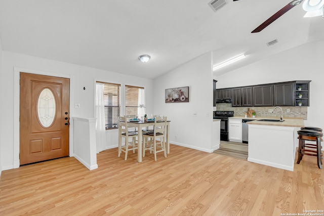 kitchen with sink, light wood-type flooring, lofted ceiling, black / electric stove, and decorative backsplash