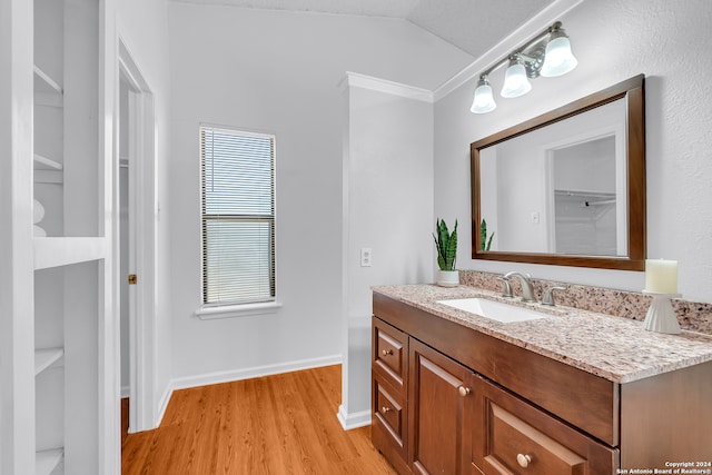 bathroom with vanity, a textured ceiling, wood-type flooring, and lofted ceiling