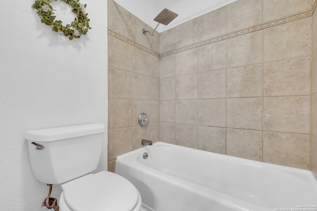 bathroom with tiled shower / bath and toilet