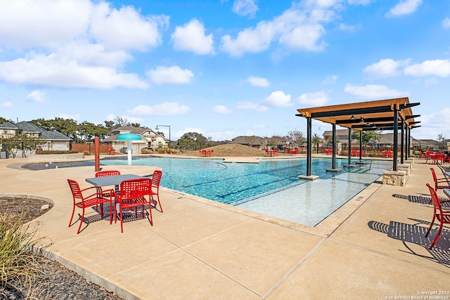 view of pool with a patio and pool water feature