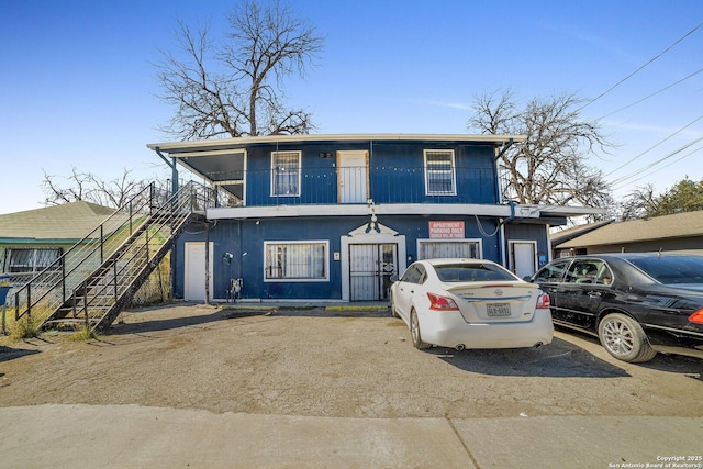 811 General Mcmullen Dr, San Antonio, TX 78237 - view of front of property featuring stairs and uncovered parking