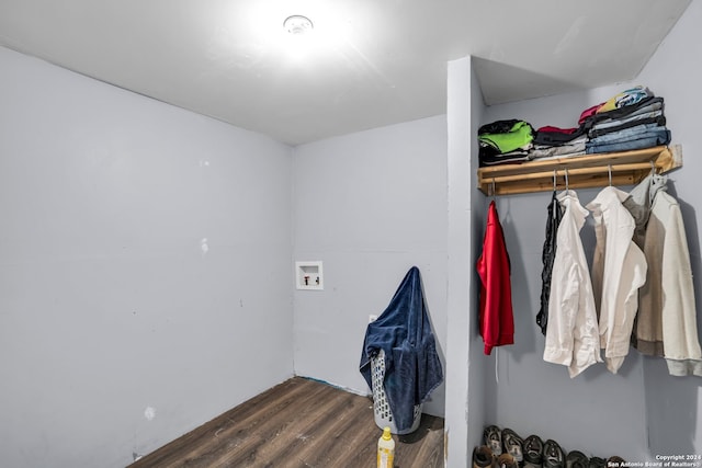 interior space with hookup for a washing machine and dark hardwood / wood-style floors