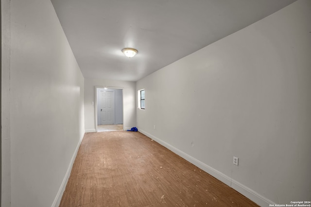 corridor with light hardwood / wood-style flooring