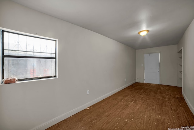 empty room with hardwood / wood-style flooring