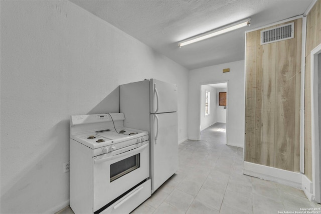 811 General Mcmullen Dr, San Antonio, TX 78237 - kitchen with a textured ceiling, baseboards, visible vents, white range with electric cooktop, and light tile patterned floors