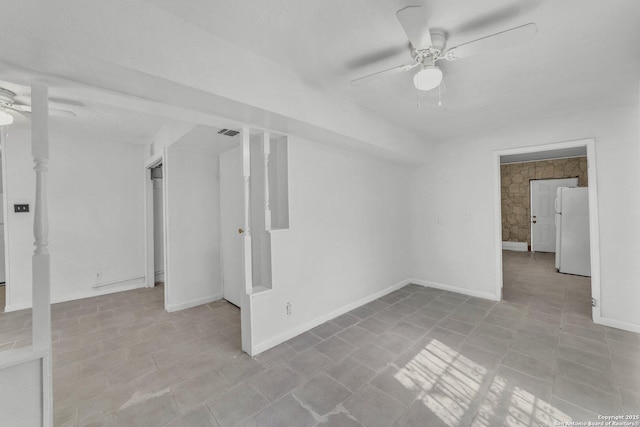 811 General Mcmullen Dr, San Antonio, TX 78237 - interior space featuring visible vents, baseboards, freestanding refrigerator, and ceiling fan