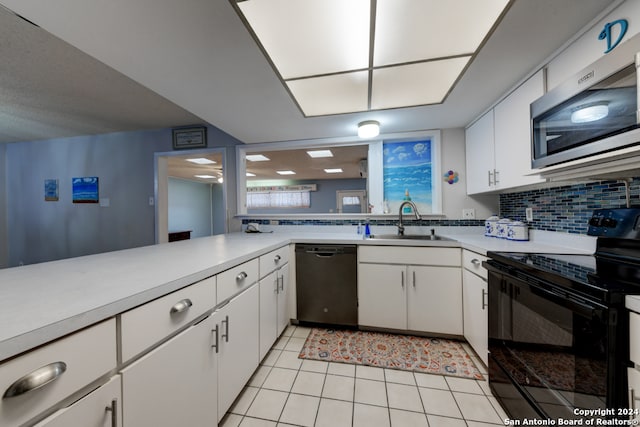 kitchen featuring black appliances, sink, decorative backsplash, and white cabinets