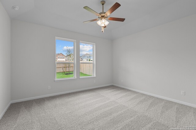 spare room featuring ceiling fan and carpet floors