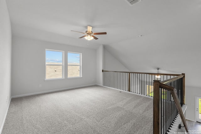 additional living space with vaulted ceiling, carpet, and ceiling fan