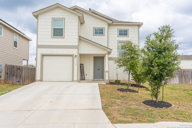 front facade featuring a front yard and a garage