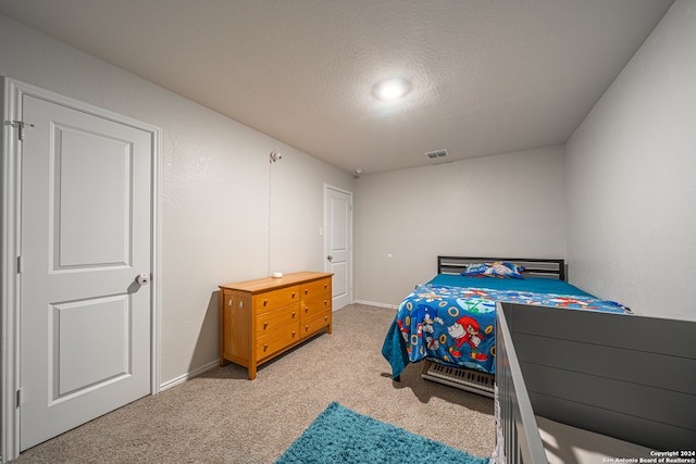 carpeted bedroom with a textured ceiling