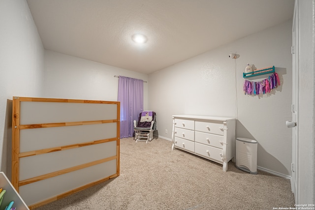 bedroom with a textured ceiling and carpet flooring