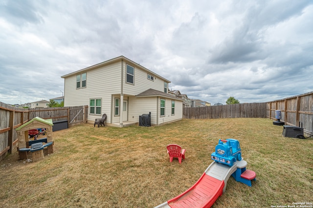 rear view of house with a lawn